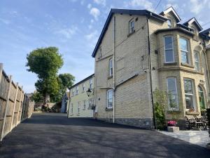 a large brick building on a street at Martris House in Rhayader
