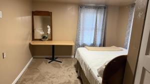 a small bedroom with a bed and a table with a mirror at Plattsburgh Stay in Plattsburgh +6 photos