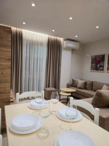 a living room with a table with wine glasses on it at A&B Seaside Residence in Golem