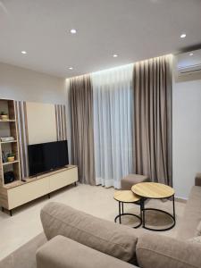 a living room with a couch and a table at A&B Seaside Residence in Golem
