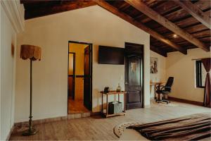 a living room with a bed and a lamp at Taura Wellness House - Boutique Stay & Experiences in Antigua Guatemala in Antigua Guatemala