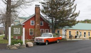 an orange and white truck parked in front of a house at Gale River House - Boutique Hotel in Franconia