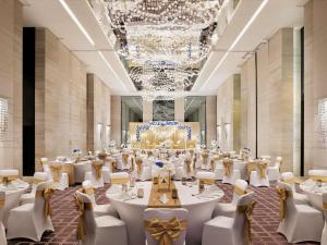 a large banquet hall with white tables and chairs at Pullman Dubai Downtown in Dubai +144 photos