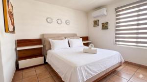 a bedroom with a white bed and a window at La Marina Condominiums by Monyxbnb in Puerto Vallarta +119 photos
