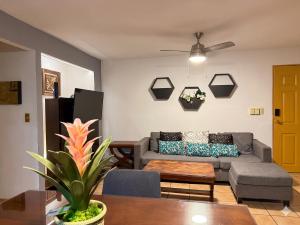 a living room with a couch and a table at La Marina Condominiums by Monyxbnb in Puerto Vallarta