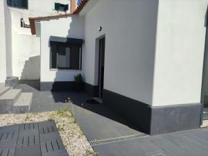 a white building with a door on the side of it at Estoril Sun in Estoril