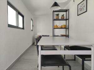a dining room with a white table and chairs at Estoril Sun in Estoril