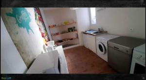 a small kitchen with a sink and a washing machine at Le Loft des Remparts in Murat