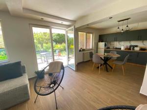 a kitchen and a living room with a table and chairs at ,,Villa Vera" Peshtani in Peštani +13 photos