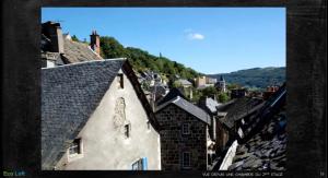 a view of a town with roofs of buildings at Le Loft des Remparts in Murat