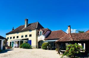 a large white building with brown roofs at La Marelle in Corberon