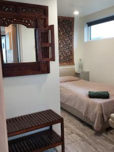 a bedroom with a bed and a mirror at North Street Sandgerði in Sandgerði