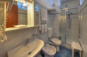 a bathroom with a sink and a toilet and a shower at Hotel Noris in Finale Ligure +53 photos