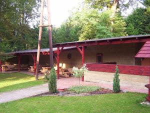 a pavilion with a picnic table in a park at Penzion U červených vrat in Chudolazy