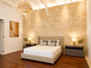 a bedroom with a white bed and two night stands at Miara - Celebrity villa in Casa de Campo! in La Romana +52 photos