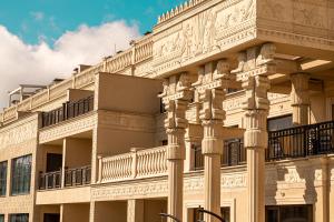 a building with columns and balconies on the side at Argisht Partez Hotel ALL INCLUSIVE & BEACH BAR REBLS in Golden Sands