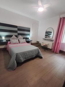 a bedroom with a large bed and a ceiling at Cortijo El Pajaroto in Matanegra