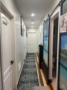 a hallway with a door and a rug at Stylish City Escape in Toronto