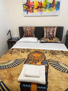 a bedroom with two beds and a painting on the wall at Stylish City Escape in Toronto