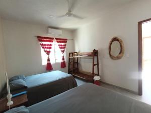 a bedroom with two beds and a window with a mirror at Casa Marbo in Malucano +42 photos