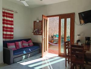 a living room with a couch and a sliding glass door at Casa Marbo in Malucano