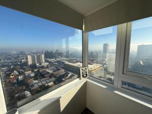 a view of a city from a large window at Departamento Blanco Encalada in Temuco