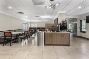 a lobby with a cafeteria with tables and chairs at Best Western Eagles Inn in Morehead