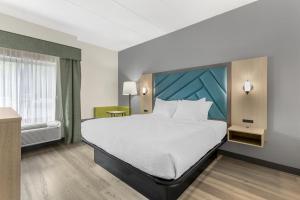 a hotel room with a large bed and a window at Best Western Eagles Inn in Morehead +40 photos