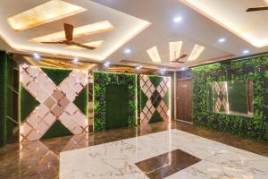 a living room with green walls and a ceiling at HOTEL O PRAGATI in Gorakhpur