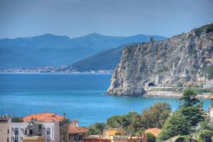 a view of a body of water next to a mountain at Hotel Noris in Finale Ligure