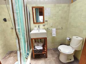 a bathroom with a sink and a toilet at Casa Santi Tepoztlán in Tepoztlán
