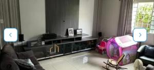 a living room with a couch and a chair in it at Nosso lar hostel in Cuiabá