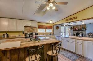 a kitchen with white cabinets and a ceiling fan at The Moseley-Smith Plantation SHARED LIVING Queen Bedroom in Aiken