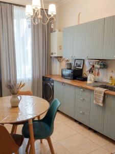 a kitchen with a table and a table and a dining room at The Velvet Stay in Tbilisi City
