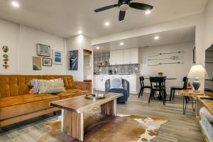 a living room with a couch and a table at 2 Mi to Lake Gregory! Chic Crestline Base Camp in Crestline