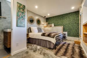 a bedroom with a bed and green walls at 2 Mi to Lake Gregory! Chic Crestline Base Camp in Crestline