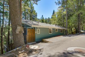 a small blue house in the middle of a forest at 2 Mi to Lake Gregory! Chic Crestline Base Camp in Crestline