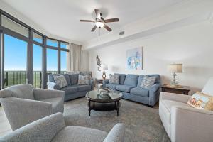 a living room with couches and a table at The Oasis at Orange Beach Unit 1816 in Orange Beach