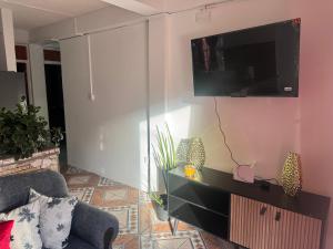 a living room with a tv on a wall at Hillside Haven in Cochrane