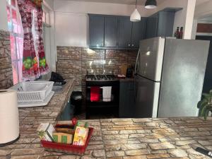 a kitchen with a stainless steel refrigerator and a counter at Hillside Haven in Cochrane