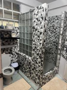 a bathroom with a shower and a toilet at Hillside Haven in Cochrane +4 photos