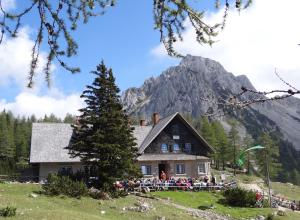 a house with a mountain in the background at Ferienwohnung Mostecky in Ferlach