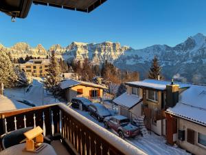 a balcony of a house with a snow covered roof at Steinbock 2OG - CharmingStay in Flumserberg