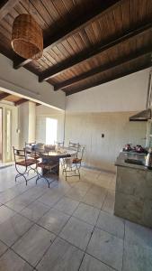a kitchen and dining room with a table and chairs at Bell Ville in Bell Ville