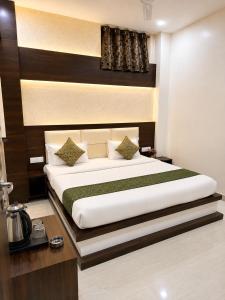 a bedroom with a large bed in a room at Hotel Pleasant Taj Agra -Budget Family AC Rooms in Tājganj