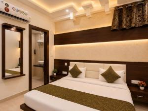 a bedroom with a large bed and a bathroom at Hotel Pleasant Taj Agra -Budget Family AC Rooms in Tājganj