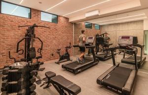 a gym with cardio equipment in a brick wall at Kukun Edition El Angel in Mexico City +31 photos