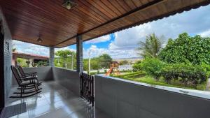a porch with a view of a playground from a house at Casa Gravatá Próximo ao Centro in Gravatá