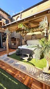 a patio with a table and a bench in a yard at Yorkshire Barn Escape 2 bedroom in Keighley