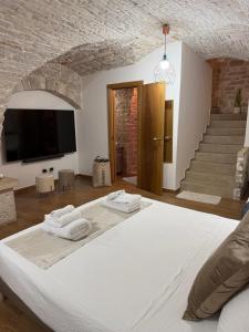 a bedroom with a large bed with two towels on it at Casa La Grotta in Bitonto